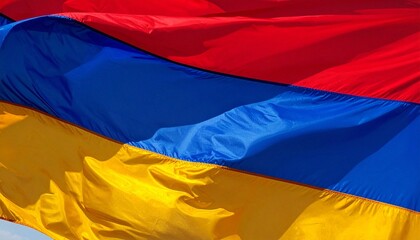 Fototapeta premium The Armenian flag with red, blue, and orange horizontal stripes, shown with realistic fabric folds.