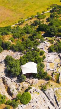 Vertical video. Tevfikiye, Turkey. Wide aerial panorama of the Troas region and the surrounding landscape from the hill of Hisarlik at ancient Troy. Aerial view, Point of interest. Rich colors