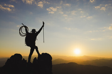 Obraz premium Mountain Man with backpack hiking in the mountains at sunset. spectacular success story, struggle, perseverance and ambition.