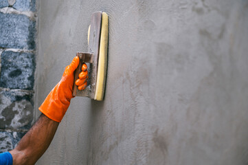 man is painting  wall with  brush