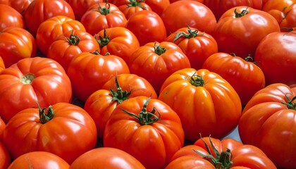 Close-up of numerous, ripe, organically grown, red fruits. They display textured skin and vibrant coloration, with green stems