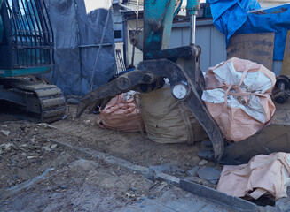 冬の街の住宅街の家を解体する重機とゴミの様子