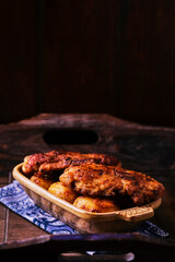  Fried chicken breast with potatoes. Rustic wooden background. Soft focus.