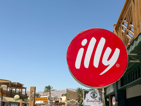 Dahab, Egypt - August 31, 2025: Illy coffee brand sign displayed along seaside promenade in resort town
