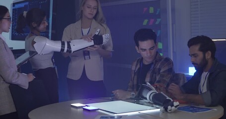 Diverse group of engineers and designers collaborates on development of robotic prosthetic arm in high-tech innovation lab. Capturing teamwork, technological creativity, human-centered product design
 - Powered by Adobe