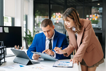 Business team analyzing data on tablet during strategy meeting in modern office, teamwork, corporate planning, financial analysis, consulting