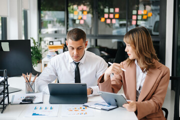 Business team analyzing data on tablet during strategy meeting in modern office, teamwork, corporate planning, financial analysis, consulting