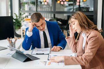 Happy businesspeople while collaborating on a new project in an office. two businesspeople using a laptop and tablet in office.