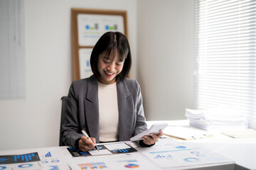 Asian businesswoman calculating finances and analyzing business data