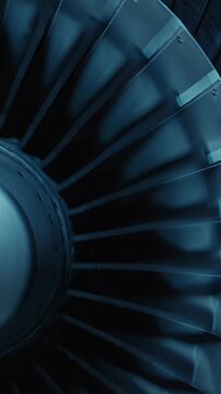 Close-up abstract of a jet engine turbine's blades in deep blue lighting