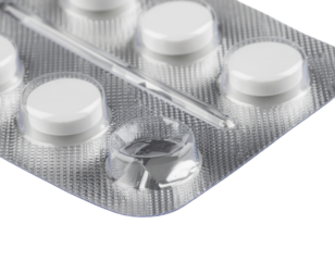 A close-up of a blister pack containing white tablets, highlighting the circular shapes and the transparent film covering the medications.