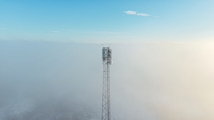 Foggy view of a tall mobile phone mast