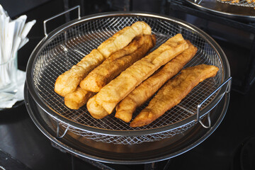 Close-up view of cakwe (or Chinese cruller, fried bread stick/ fritters, oil stick, doughnut, char)