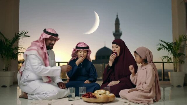 The concept of breaking the fast for an Islamic family in the month of Ramadan using the crescent moon and mosque. 