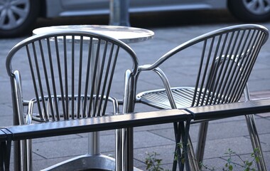 two chairs in the sidewalk