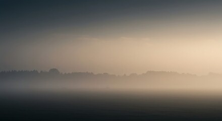 Obraz premium Soft, diffused light washing over a distant landscape obscured by heavy atmospheric haze, creating a peaceful, muted backdrop effect suitable for design, background, abstract, mysterious