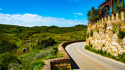 Obraz premium Winding road through the beautiful green hills and vineyards of Tuscany. Montefioralle, Italy.
