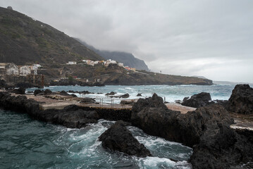 The natural pools of Garachico, Tenerife, Spain, are volcanic formations shaped by the 1706 eruption. Surrounded by rugged lava rock, they offer crystal-clear waters