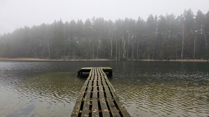 Misty Lake Pier: A Solitary Journey