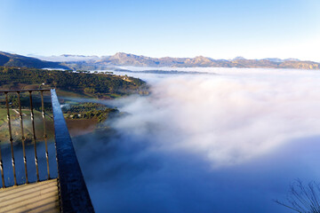 ronda,malaga,spain Ronda valley and surrounding mountains emerging from a thick blanket of fog and mist at sunrise, viewed from above