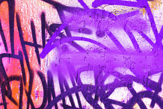 Abstract graffiti art in purple, orange on cracked wall surface. Urban street style, colorful spray paint, textured background, vibrant overlay. Posters, flyers, digital art, banner, urban visuals