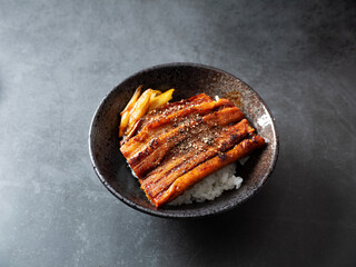 a bowl of boiled eel and rice