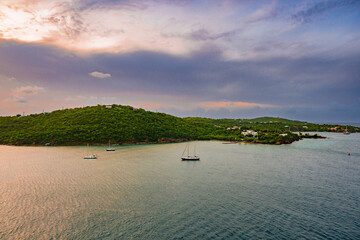 St. Thomas sunrise with sailboats, mountains, and sky