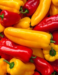 Close-up of vibrant red and yellow peppers, a mix of shapes and sizes. The colorful produce is arranged tightly
