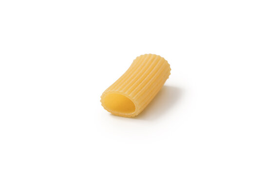Italian dry rigatoni pasta over white background with shadow