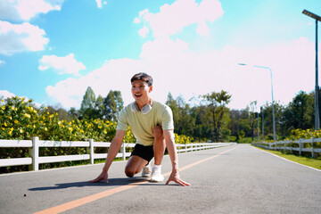 Smiling active man standing in start position, jogging running and walking doing fitness in the park