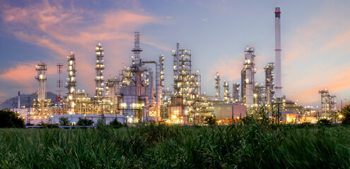 Oil and gas industrial refinery at twilight, Oil refinery and Petrochemical plant pipeline steel, Refinery factory oil storage tank and pipeline steel at night.