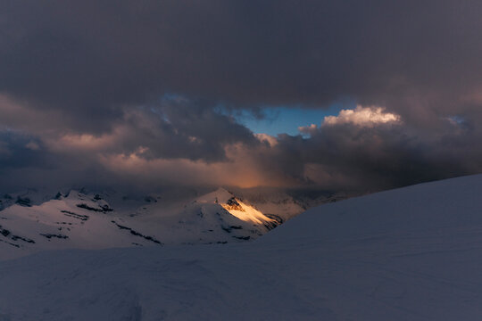 Light illuminates a mountain top in the Northern Rockies in Canada.