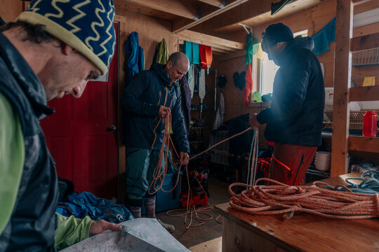 Three skiers prepare to ski in the backcountry in Canada.
