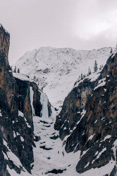 Three skiers descend a icefall section in the mountains of Canada.