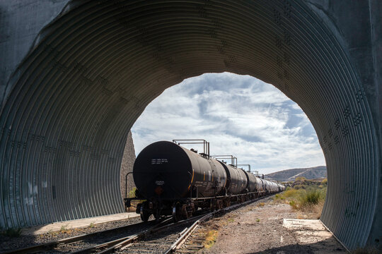 End of train of tank cars in corrugated metal tunnel