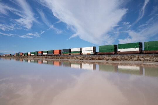 Container stack train reflected in standing water
