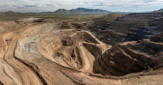 Layers of earth revealed in an open pit mining operation