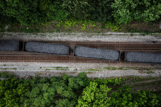 Overhead looking down on coal train crossing tracks