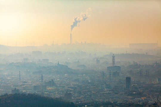 Wide view of town enveloped in smog pollution