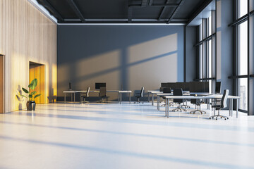 Modern open space office interior with sunlight casting shadows across desks, chairs, wooden walls, and large windows in a corporate building. 3D Rendering