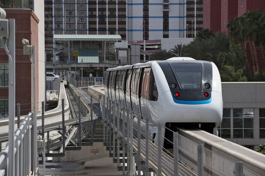White driverless automatic Las Vegas 4-cars monorail train goes between two central stations. Las Vegas, Nevada, USA