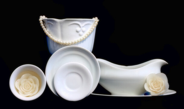 White dishes on black background