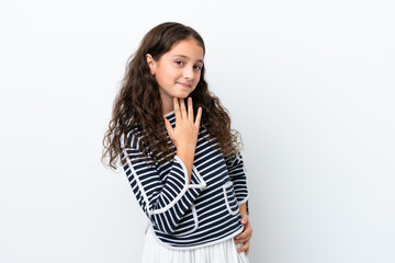 Obraz premium Little caucasian girl isolated on white background looking up while smiling