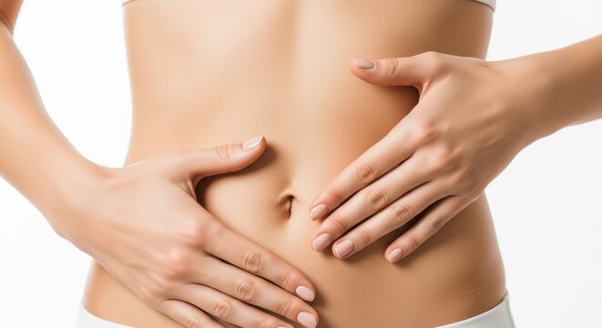 Woman's bare torso with hands gently touching abdomen