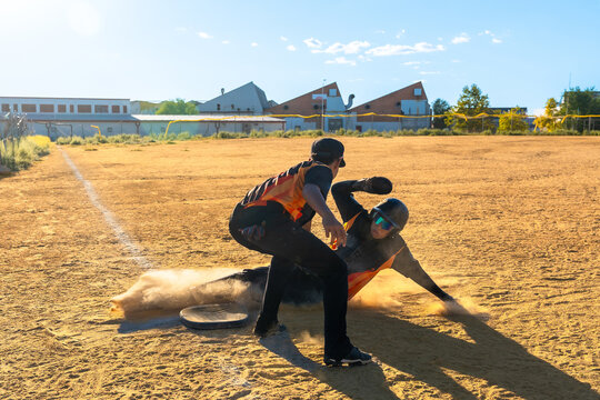Baseball player sliding into base during game - Powered by Adobe