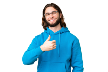 Young handsome man over isolated chroma key background giving a thumbs up gesture