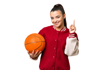 Young Woman playing basketball over isolated chroma key background showing and lifting a finger in sign of the best