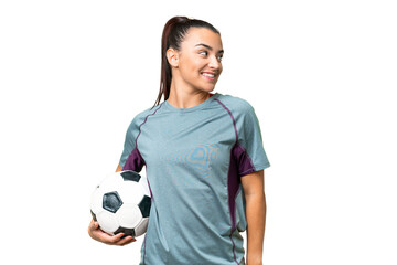 Young football player Woman over isolated chroma key background looking to the side and smiling © luismolinero