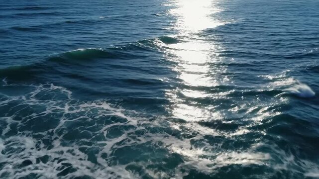 A serene ocean wave glistens in the sunlight in this calming video