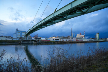 The Gersthofen industrial park is a chemical and industrial site with futuristic-looking buildings and silo facilities. The green bridge construction spans the Lech Canal